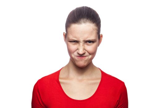 Portrait of cunning woman in red t-shirt with freckles. looking at camera, studio shot. isolated on white background.