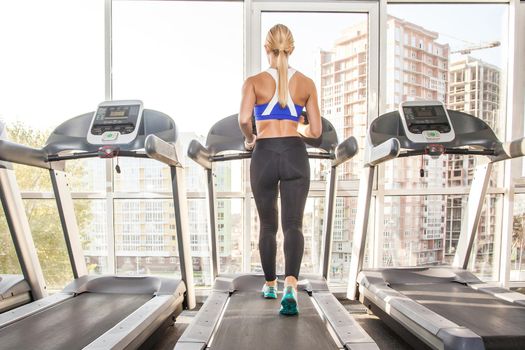 Active athletic woman with perfect body, jogging on racetrack in the morning. Studio shot