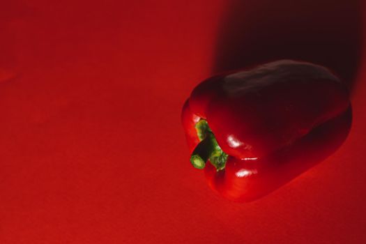 SWEET PEPPER ON A RED BACKGROUND