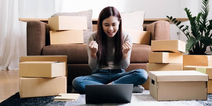 Portrait of Starting small businesses SME owners female entrepreneurs working on receipt box and check online orders to prepare to pack the boxes, sell to customers, SME business ideas online..