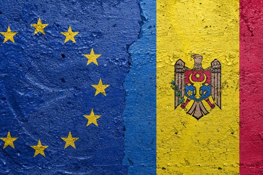 European Union and Moldova flags  - Cracked concrete wall painted with a EU flag on the left and a Moldovan flag on the right