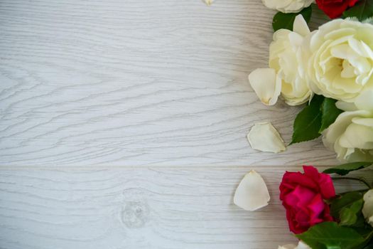 beautiful background of many red roses on a light wooden