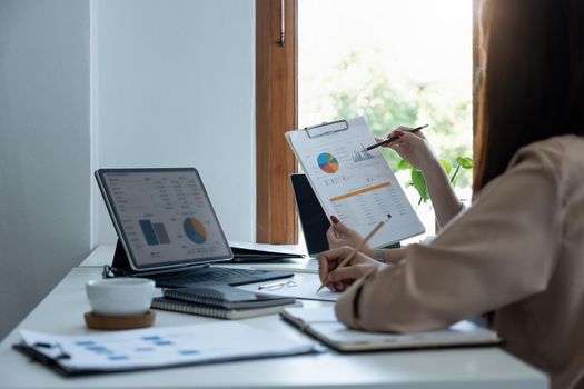Asian business adviser meeting to analyze and discuss the situation on the financial report in the meeting room.Investment Consultant, Financial advisor and accounting concept.