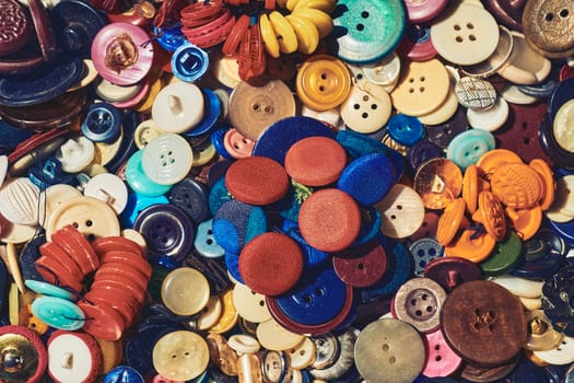 person whose occupation is making fitted clothes such as suits, pants, and jackets to fit individual customers.A large number of different multi-colored buttons.