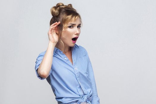 I can not hear you. Beautiful young adult lady. Studio shot, gray background
