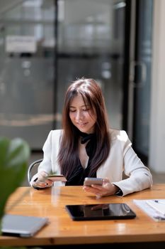 Young woman holding credit card and using smart phone for online shopping. Online payment shopping concept. copyspace banner.