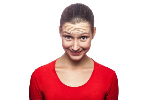 Portrait of cunning woman in red t-shirt with freckles. looking at camera, studio shot. isolated on white background.