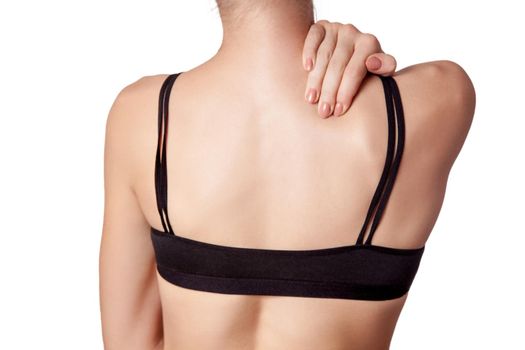 Closeup view of a young woman with shoulder or neck pain on white background.