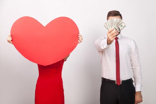 Love or money? Which is better, your choice. Indoor, studio shot, isolated on gray background