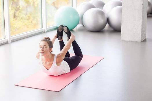 VIew from above. Happiness woman doing yoga, bow posture, yoga. Studio shot