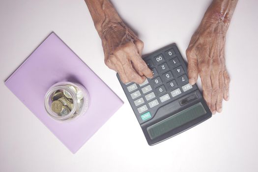 senior women hand using calculator on desk .