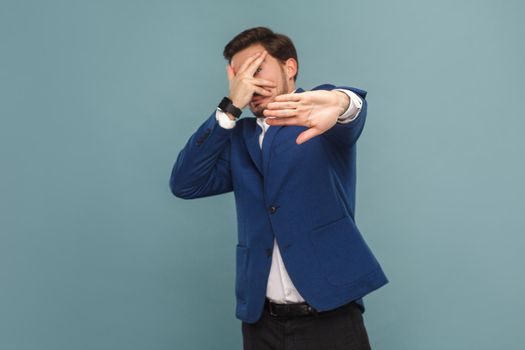 Nervous businessman scared and panic. Business people concept, richly and success. Indoor, studio shot on light blue background