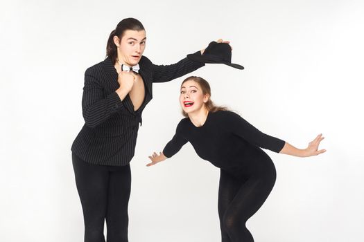 Two comedian circus artist posing and looking at camera. Studio shot, isolated on white background