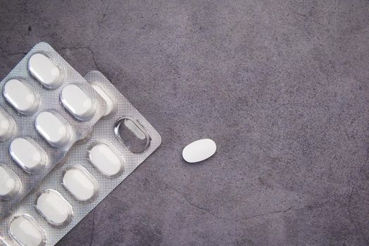 Close up of pills of blister pack on table .