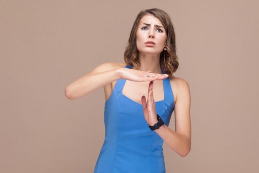 Please, i need pause! Woman need time out. Studio shot on light brown background