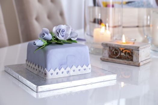 Beautiful decorated fruit cake with blue roses.