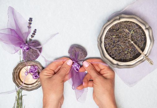 dry lavender stems for making sachets in a beige tray on a wooden table top view, Bouquet of purple flowers, Flat lay, top view, natural soothing aromatherapy,high quality photo