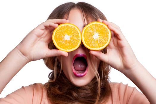 Young beautiful funny girl with orange slice and makeup and hairstyle looking at camera. studio shot, isolated on white background. .
