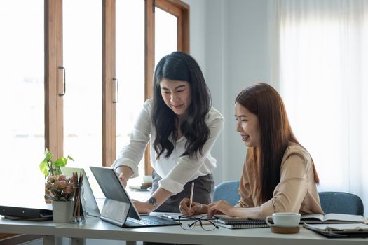 Asian business adviser meeting to analyze and discuss the situation on the financial report in the meeting room.Investment Consultant, Financial advisor and accounting concept.