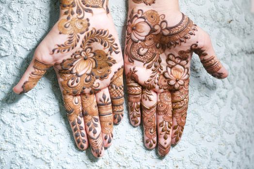 women applying henna on hand .