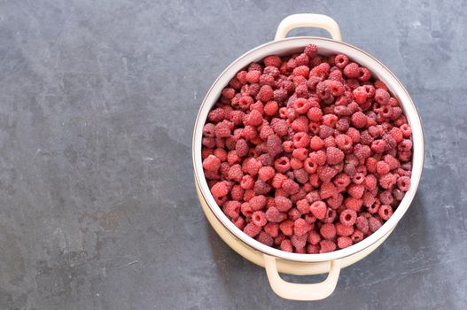 a full pan of ripe raspberries and a spoon for jam, a large harvest of healthy berries, a healthy diet, Favorite delicacy, preservation of Natural vitamins for the winter