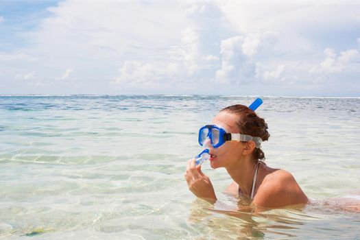 Happy woman on the beach with a diving mask. Bali, Indonesia. Stock image.