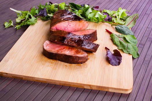 Beef grilled with blood on the kitchen blackboard. Stock image.