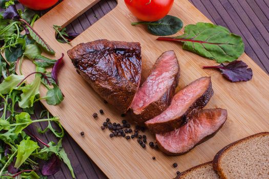 Beef grilled with blood on the kitchen blackboard. Stock image.