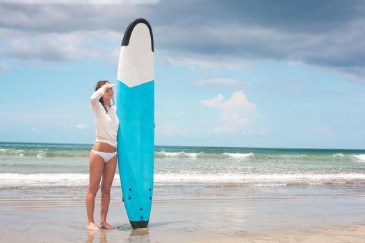 Girl on the waves in the ocean with her Surfboard. Stock image