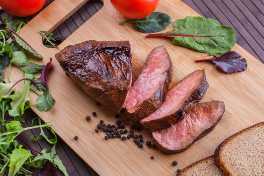 Beef grilled with blood on the kitchen blackboard. Stock image.