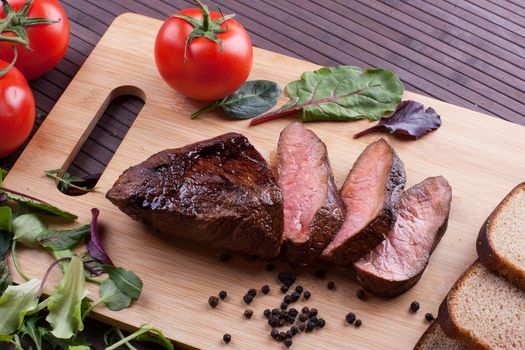 Beef grilled with blood on the kitchen blackboard. Stock image.