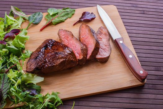 Beef grilled with blood on the kitchen blackboard. Stock image.