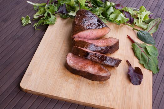 Beef grilled with blood on the kitchen blackboard. Stock image.