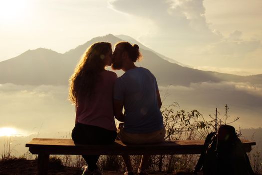 Happy couple in the sun on a background of mountains. stock image.