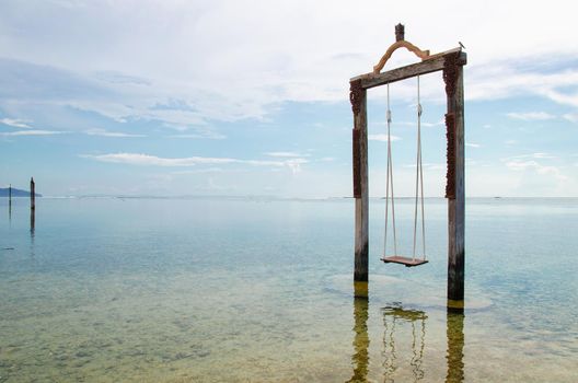Bali, Indonesia. Swing located in the ocean near the island of Gili. Stock Image