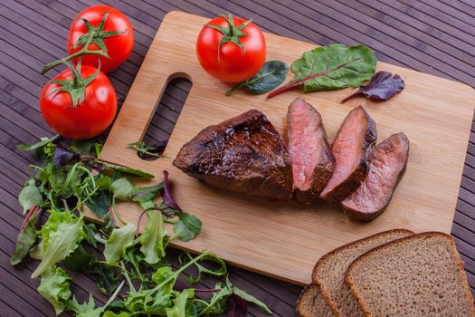 Beef grilled with blood on the kitchen blackboard. Stock image.