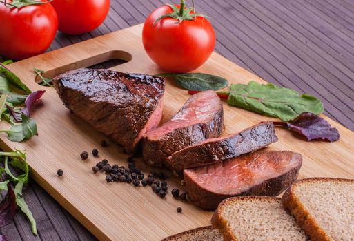 Beef grilled with blood on the kitchen blackboard. Stock image.