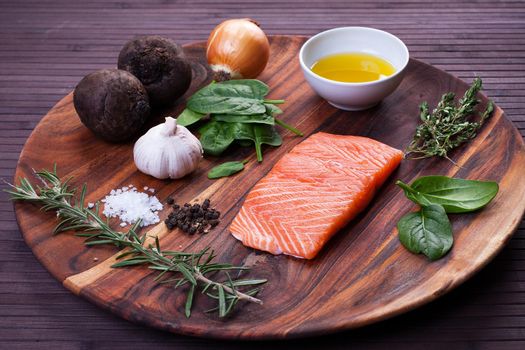 Salmon fillet with baked beetroot on a black plate. Stock image.