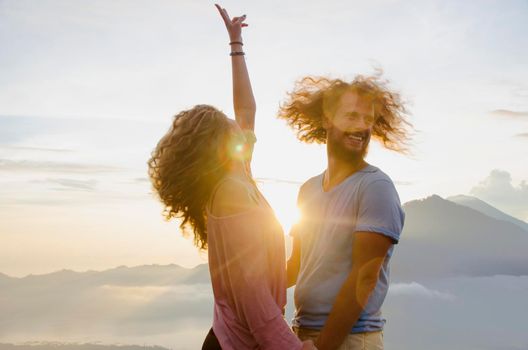 Happy couple in the sun on a background of mountains. stock image.