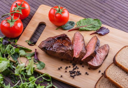 Beef grilled with blood on the kitchen blackboard. Stock image.