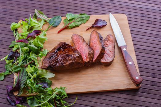 Beef grilled with blood on the kitchen blackboard. Stock image.