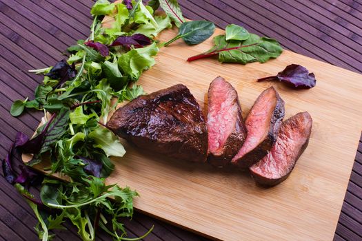 Beef grilled with blood on the kitchen blackboard. Stock image.