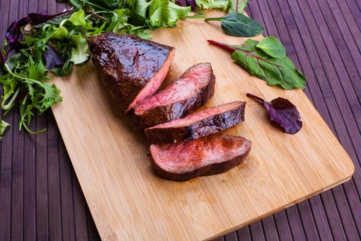 Beef grilled with blood on the kitchen blackboard. Stock image.