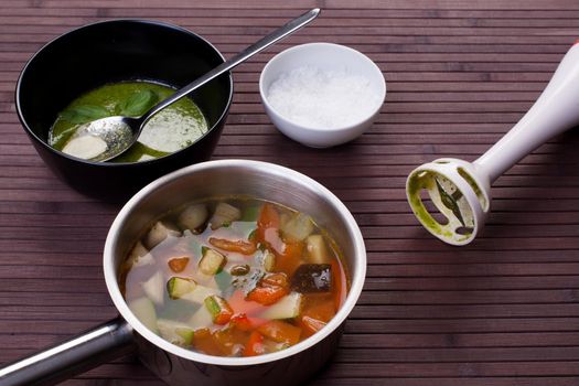 vegetable soup with pesto on the table. Stock image.