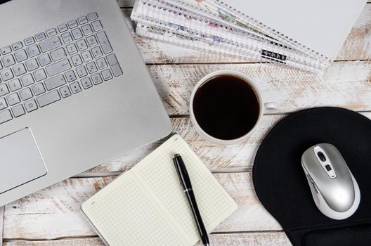 Cup of coffee and laptop on wooden table. Stock image.