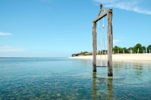 Bali, Indonesia. Exotic beach. Swing located in the ocean near the island of Gili. Stock Image