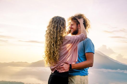 Happy couple in the sun on a background of mountains. stock image.