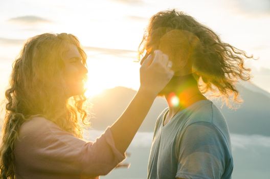 Happy couple in the sun on a background of mountains. stock image.