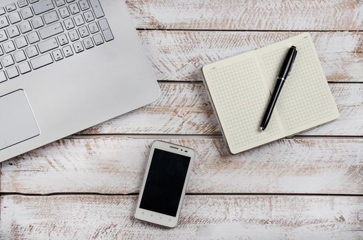 Cup of coffee and laptop on wooden table. Stock image.