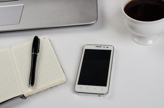 Cup of coffee and laptop on wooden table. Stock image.